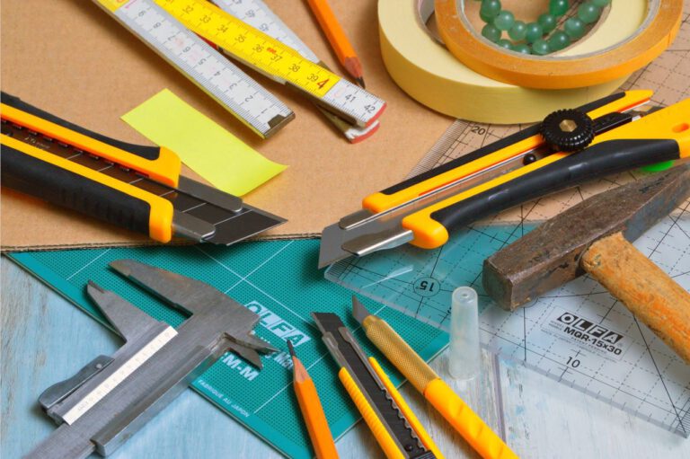 Mastering the First Impression: Your intriguing post title goes here A variety of crafting tools including cutters, ruler, and tape on a work desk.