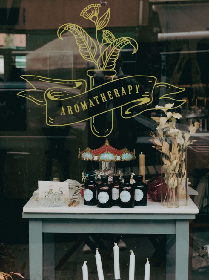 The Art of Drawing Readers In: Your attractive post title goes here A beautifully arranged aromatherapy storefront with candles, essential oils, and decor.